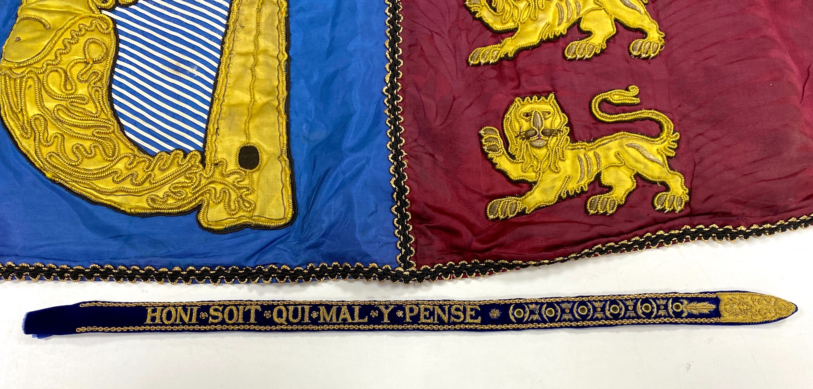 Two QEII Officer's of Arms of The Herald's College embroidered tabards and a similar silk garter, possibly worn for the Coronation of the Queen in 1953